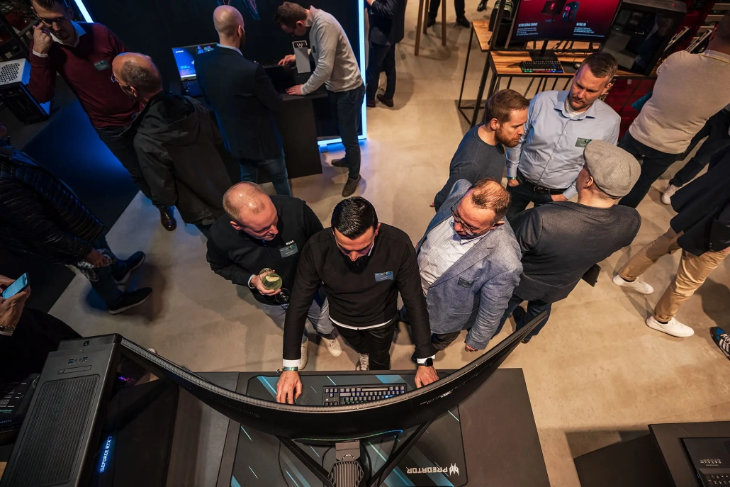 a group of people standing around a large black computer